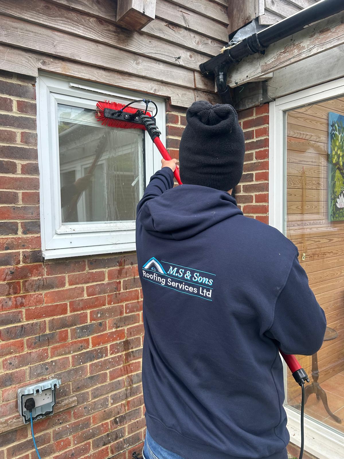 M.S & Sons technician cleaning a window